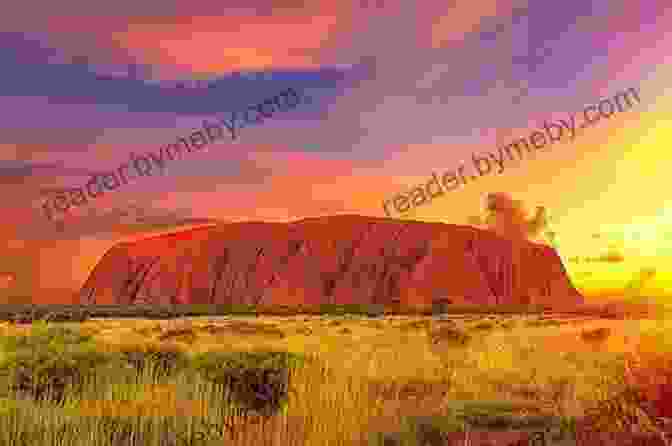 A Breathtaking Sunset Over Uluru (Ayers Rock),With Its Vibrant Colors Reflected In The Still Waters Of A Nearby Waterhole. 4WD Australia: The Best Short Getaways