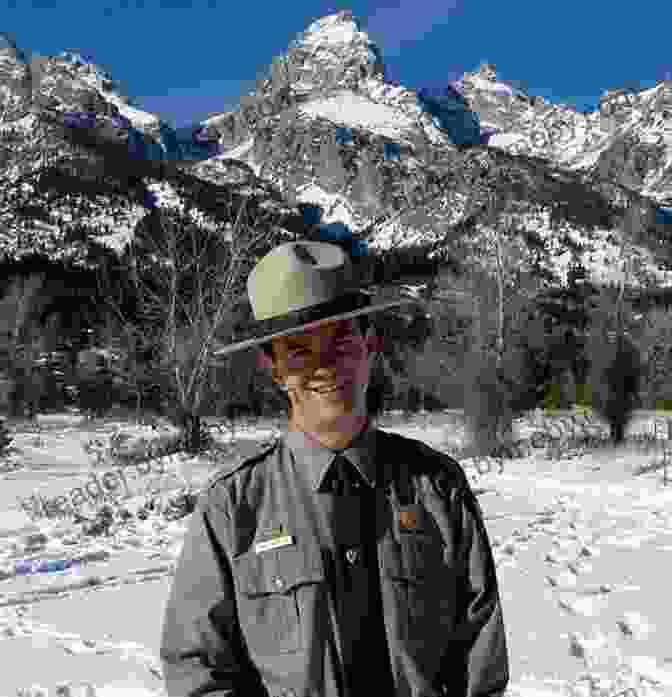 A Park Ranger In Uniform Standing In Front Of A Mountain Range Trip Tales: From Family Camping To Life As A Ranger