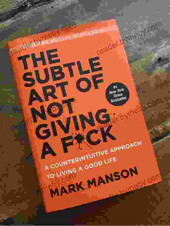 Mark Manson, The Author Of 'The Subtle Art Of Not Giving A F*ck,' Smiling And Holding A Copy Of His Book. Summary Of The Subtle Art Of Not Giving A F*CK: A Counterintuitive Approach To Living A Good Life By Mark Manson